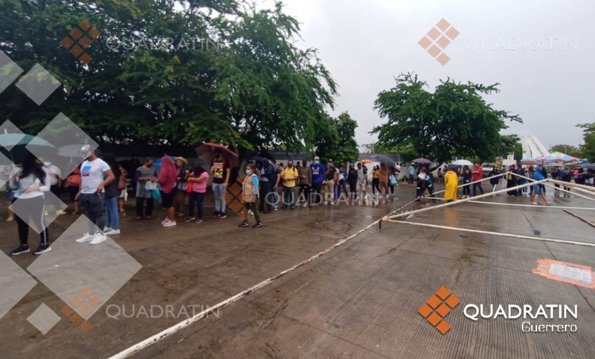 Jóvenes esperan la vacuna desde la madrugada y bajo la lluvia en Iguala